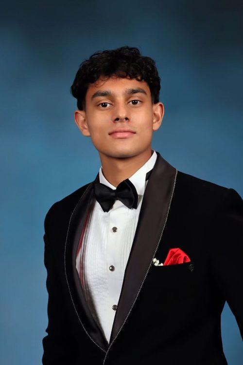Portrait of Hiranya Agarwal wearing a black dinner jacket.